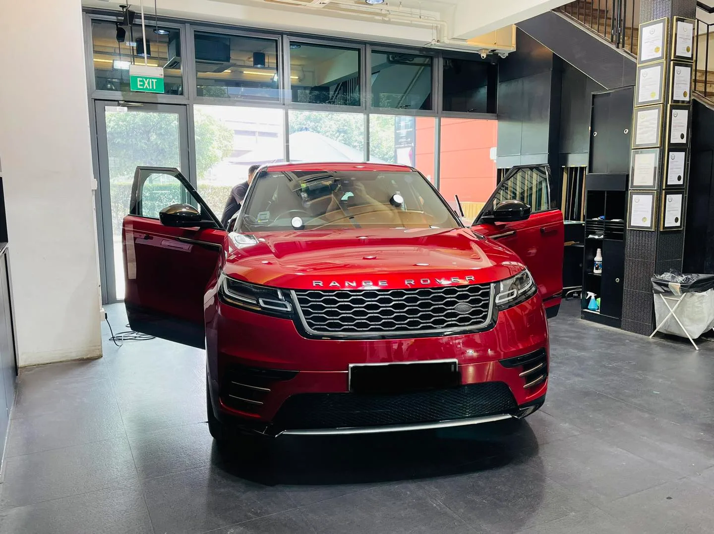 Red Range Rover Velar with door open during window tinting at Infratint Singapore