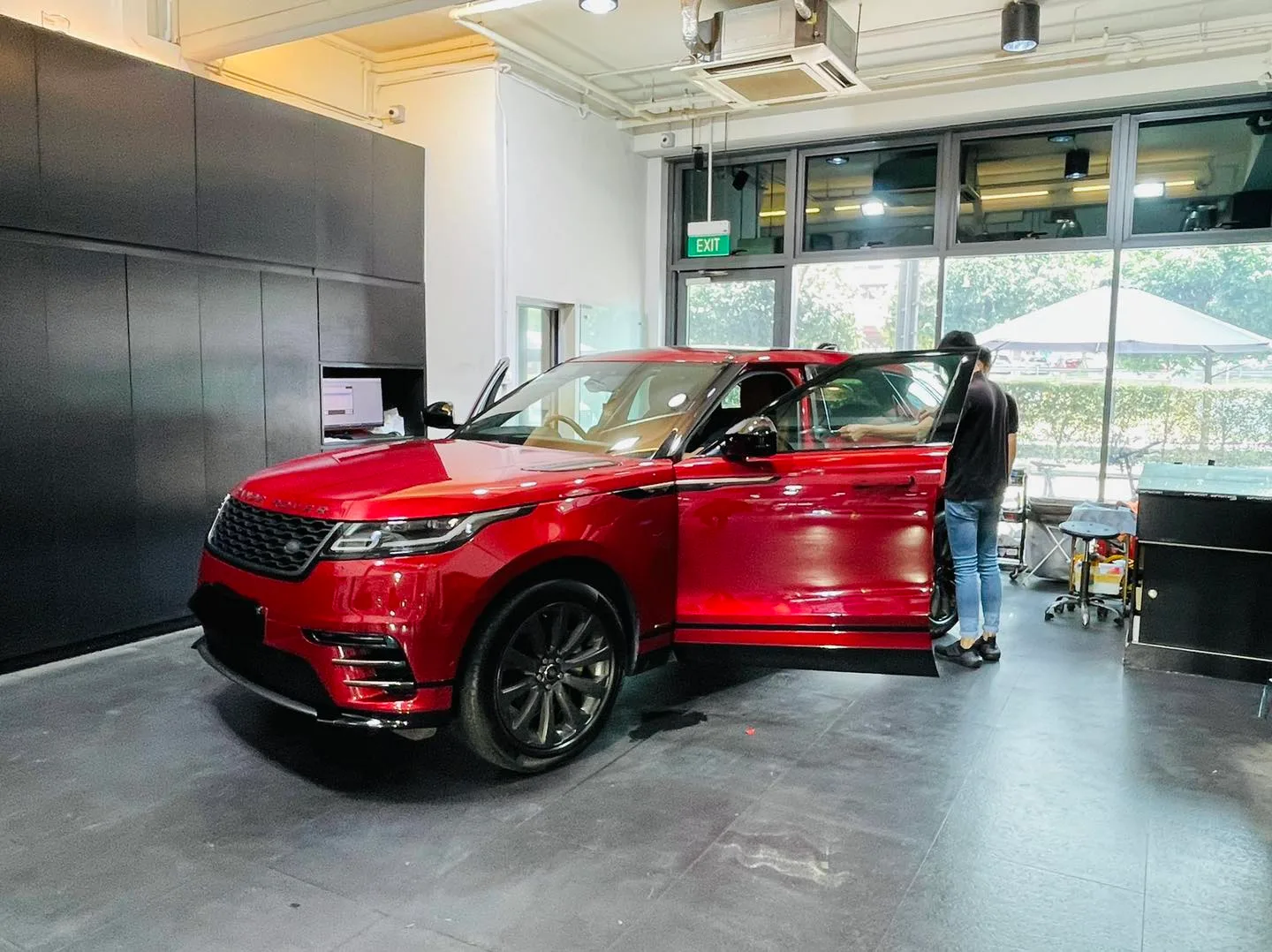 Red Range Rover Velar at a front three-quarter angle at Infratint Singapore