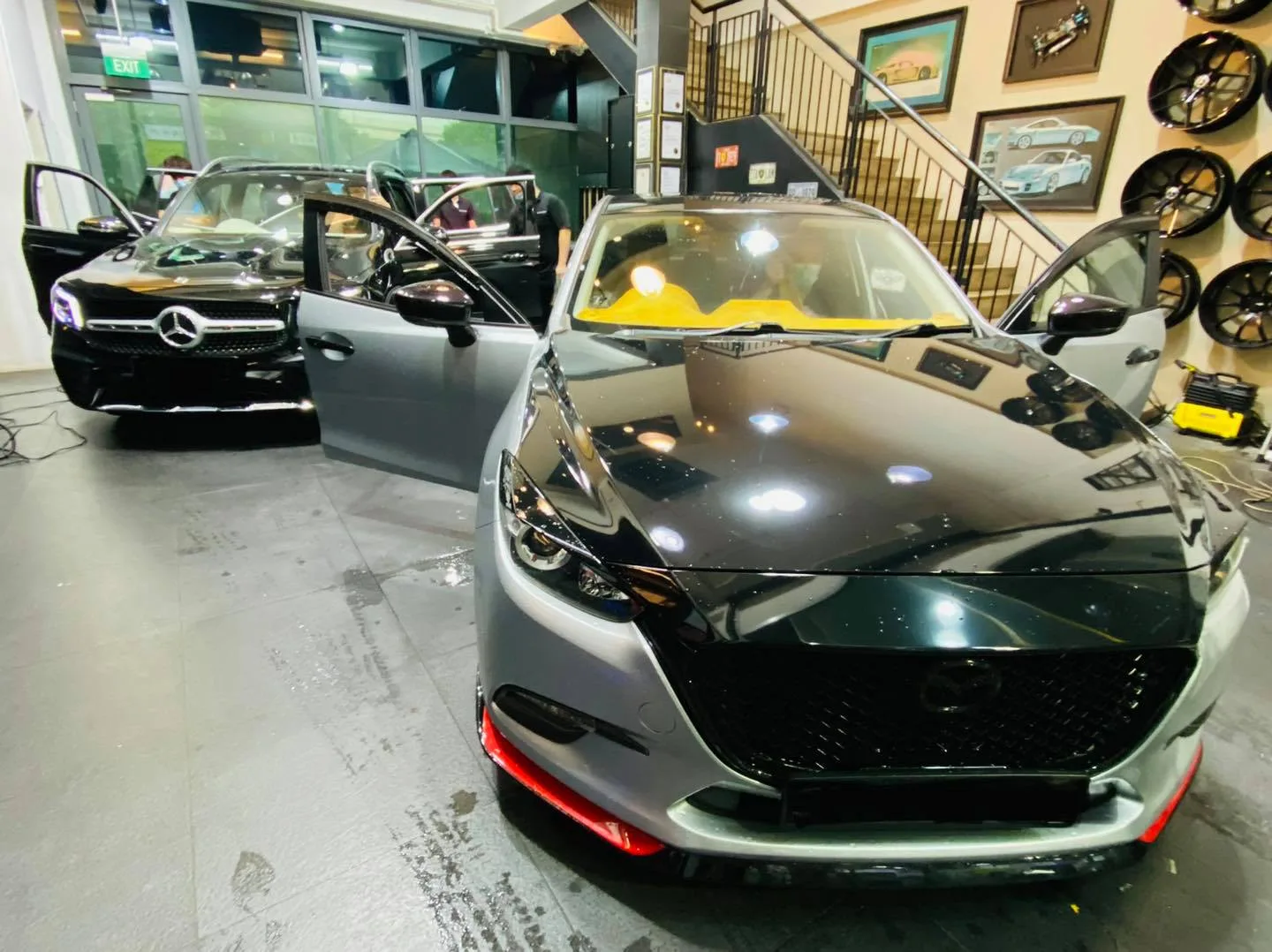Black Mazda 3 hatchback with doors open at Infratint Singapore for window tinting