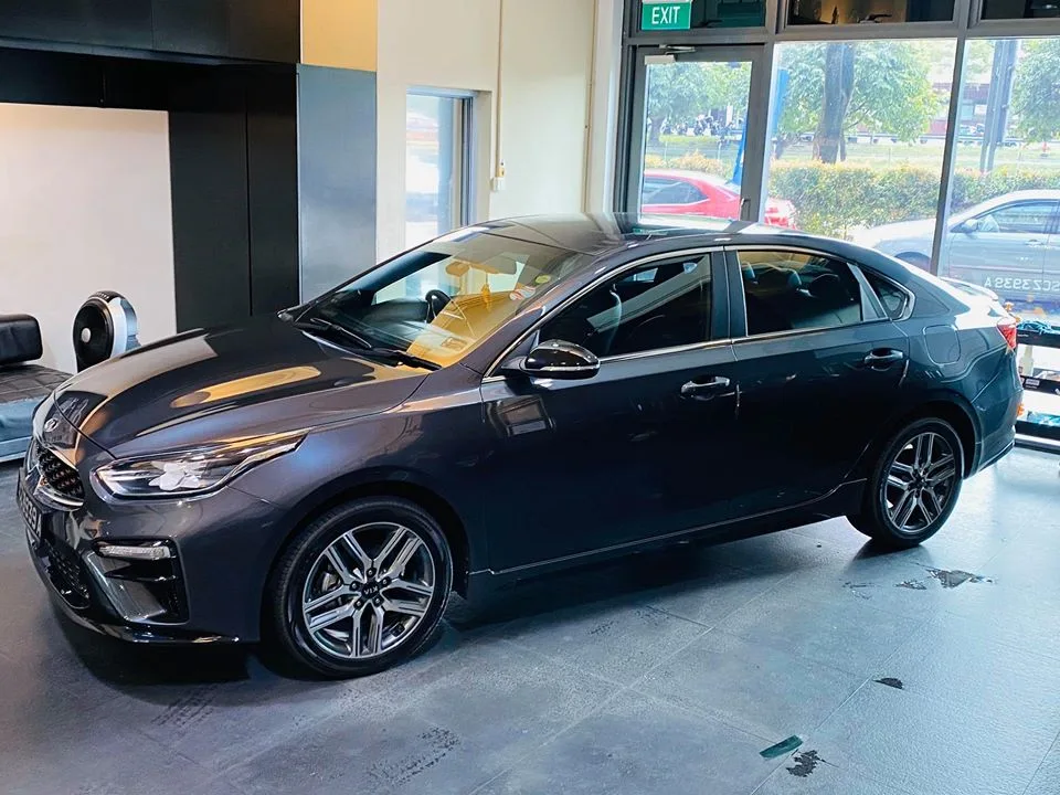 Grey Kia Cerato sedan side profile after window tinting at Infratint Singapore