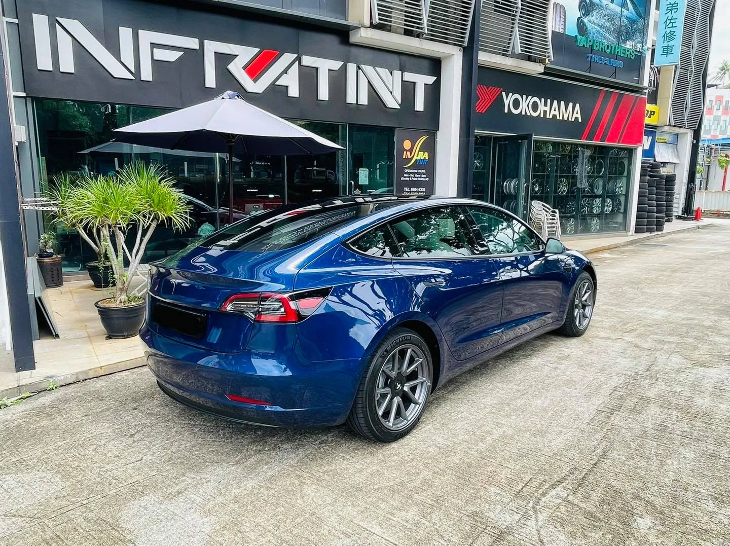 Blue Tesla Model 3 rear view outside Infratint Singapore