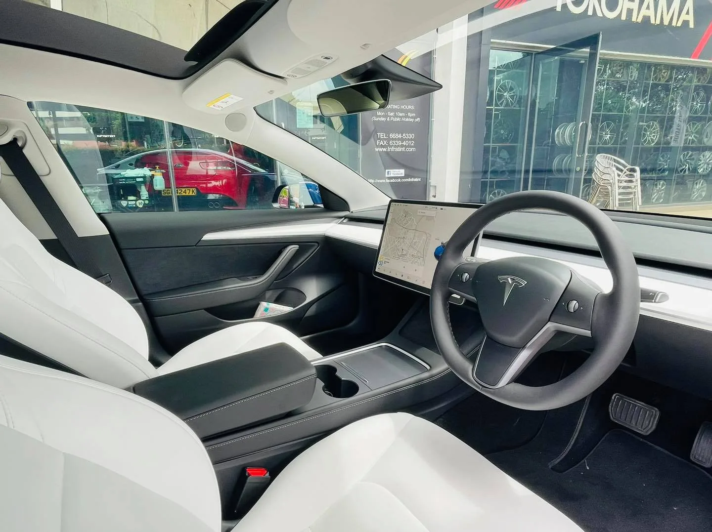 Tesla white interior viewed through tinted windows at Infratint Singapore