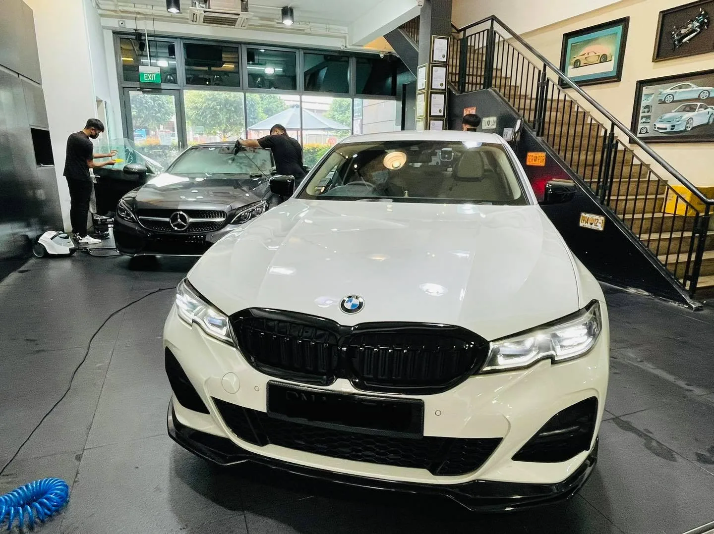 White BMW 3 Series and silver Mercedes-Benz during tinting at Infratint Singapore