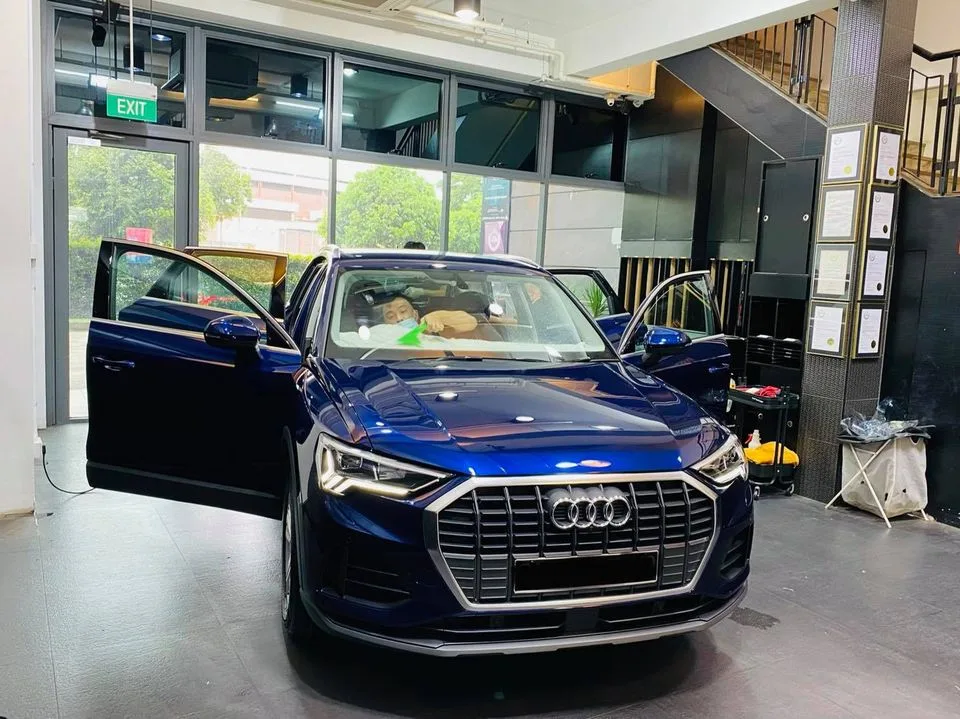 Blue Audi Q3 SUV with doors open during window tinting at Infratint Singapore