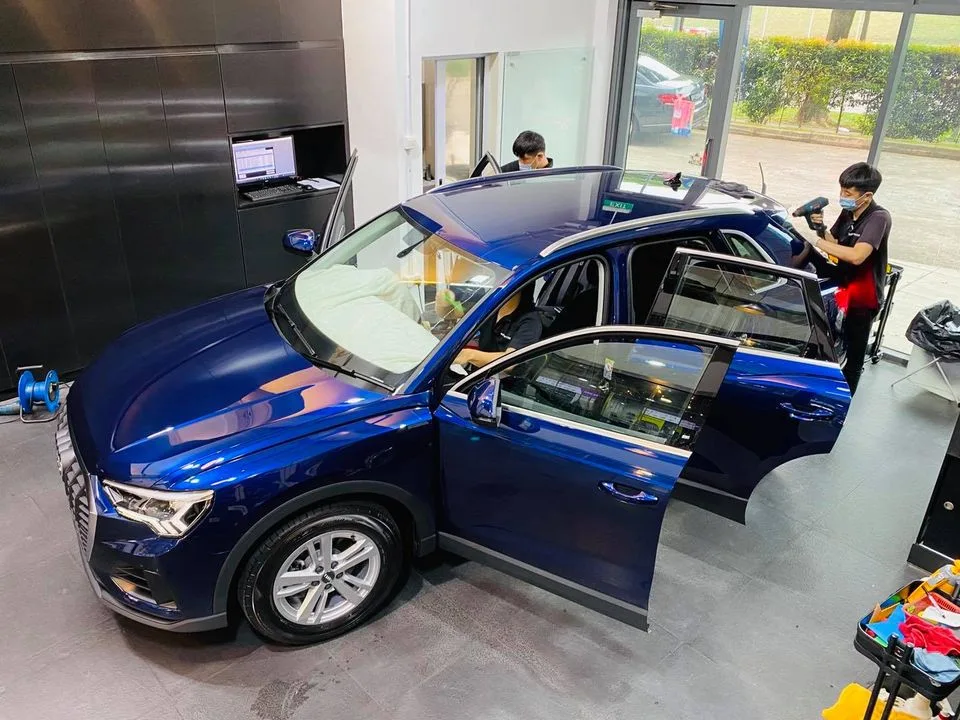 Overhead view of a blue Audi Q3 during tinting at Infratint Singapore