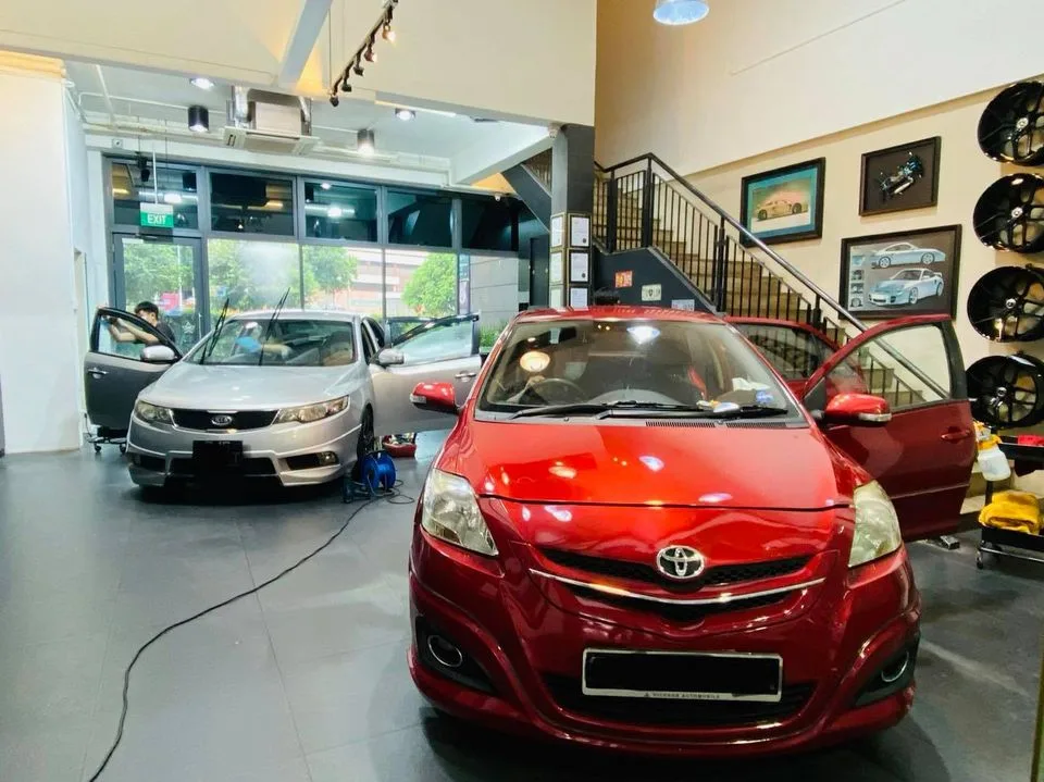 Red Toyota Vios head-on with a silver Kia at Infratint Singapore for window film