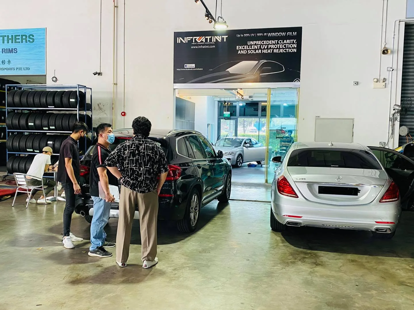 Black SUV and silver Mercedes-Benz S-Class in the Infratint Singapore workshop