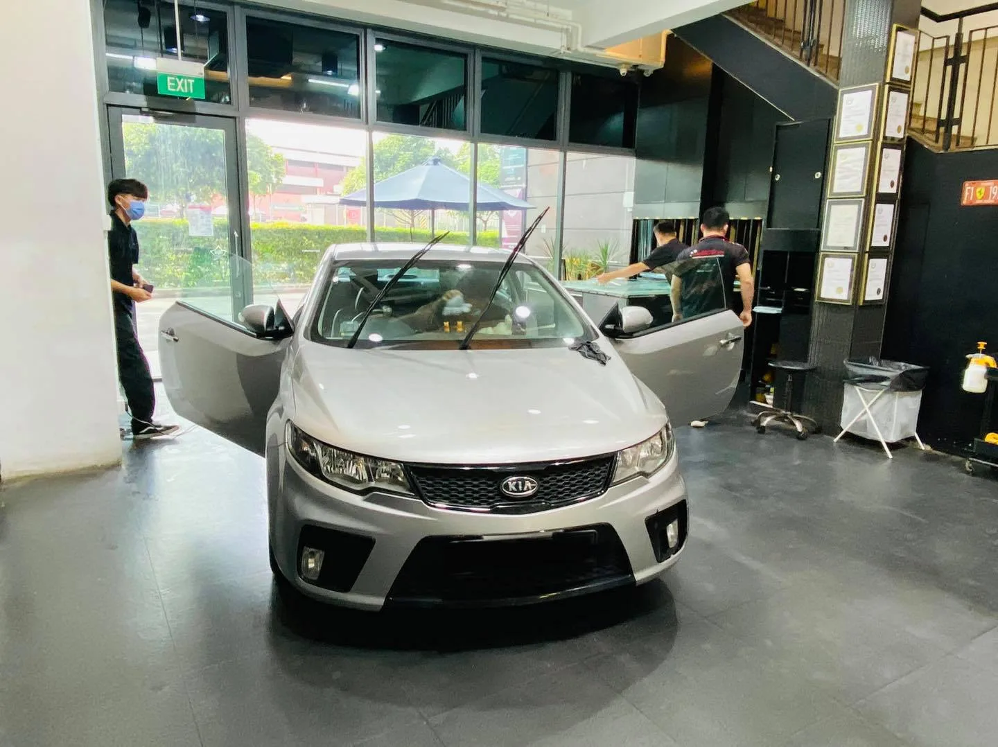Front view of a silver Kia coupe with doors open at Infratint Singapore