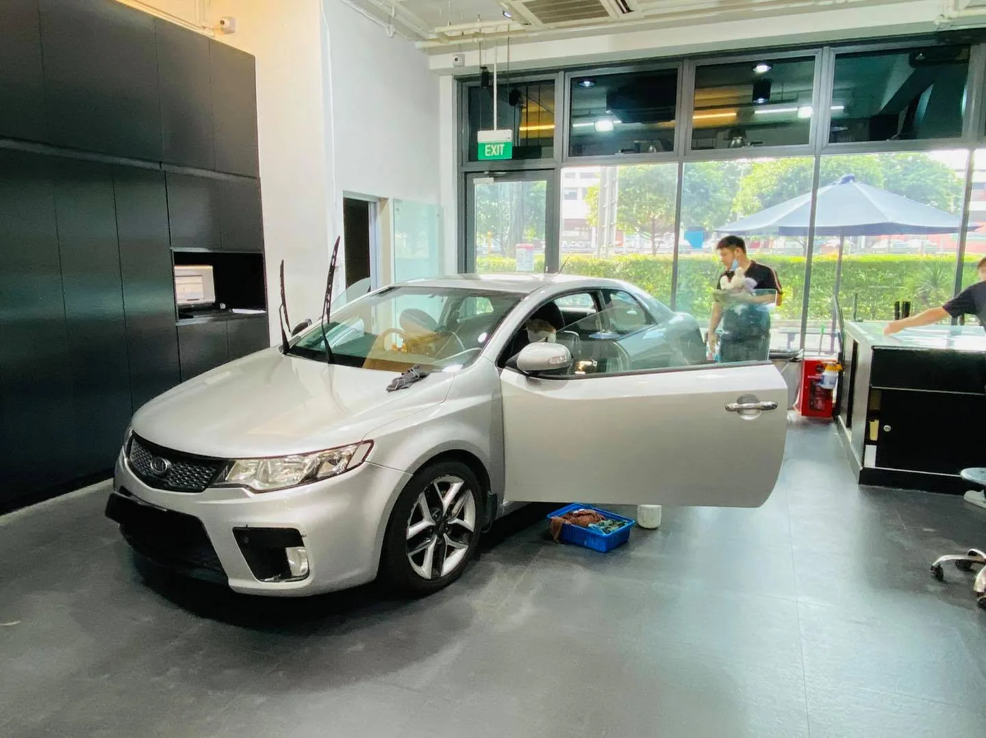 Silver Kia coupe with door open during window tinting at Infratint Singapore