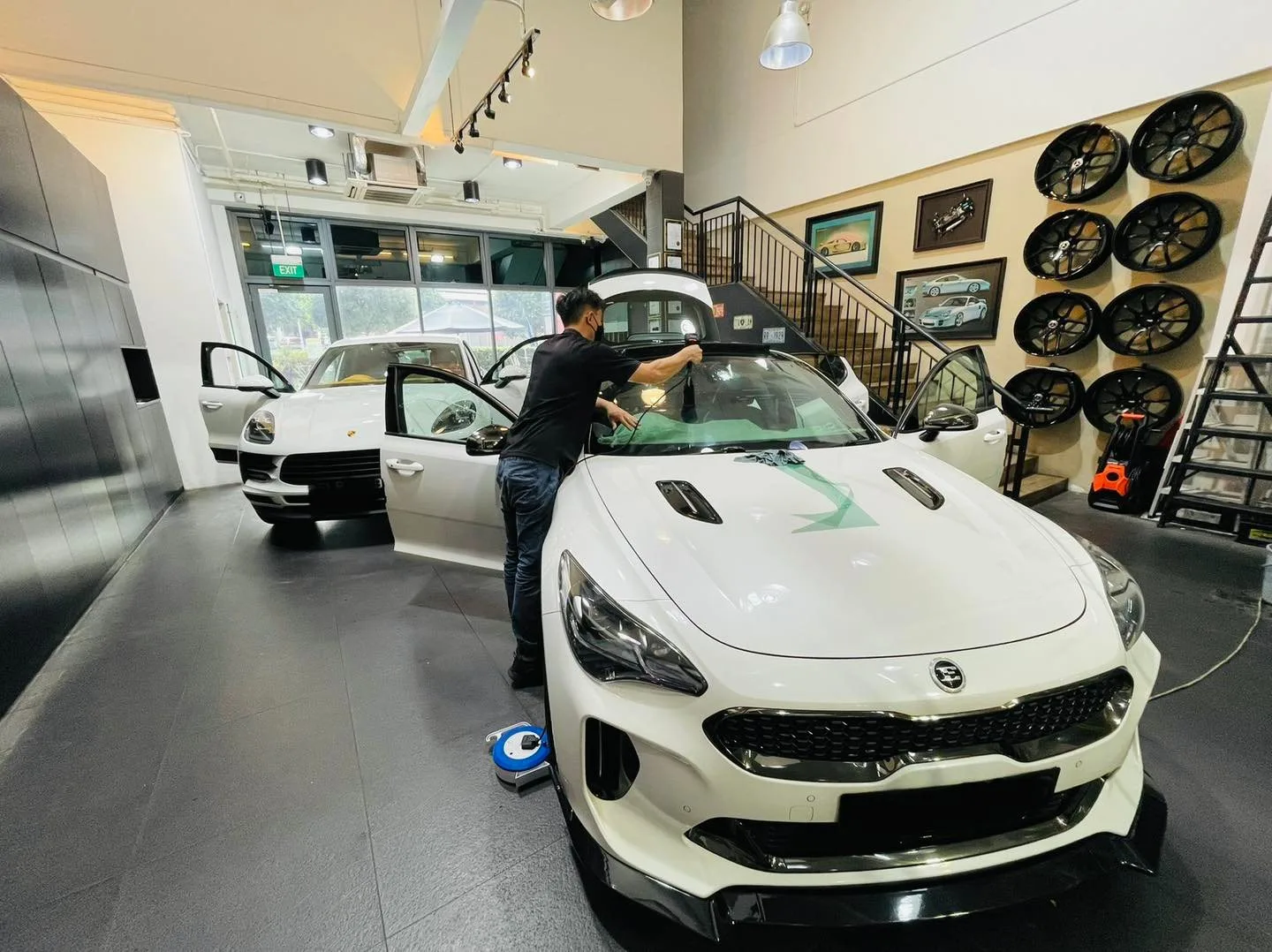 White Kia being tinted by a technician at Infratint Singapore