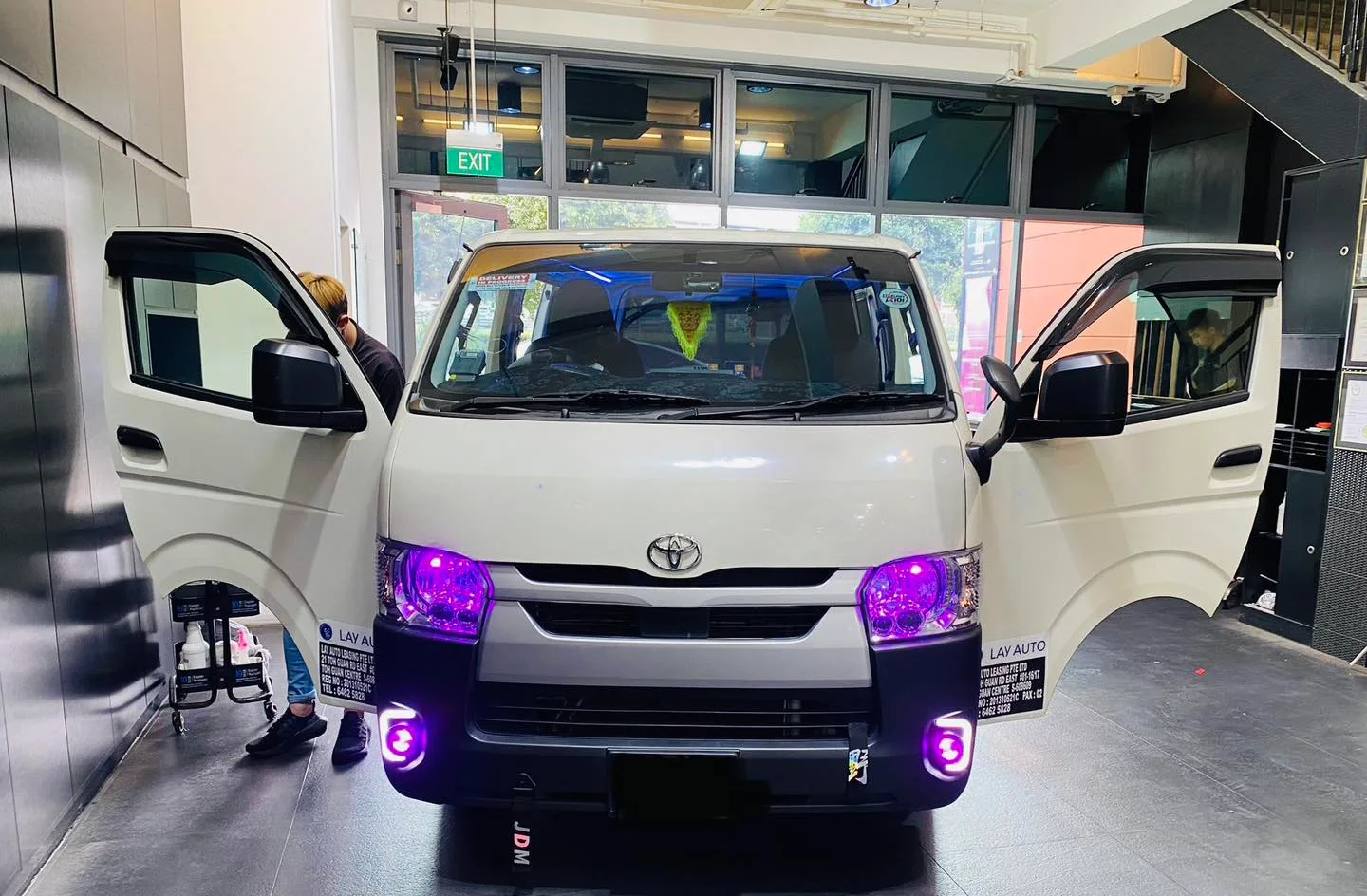 White Toyota Hiace van with purple-lit headlights at Infratint Singapore