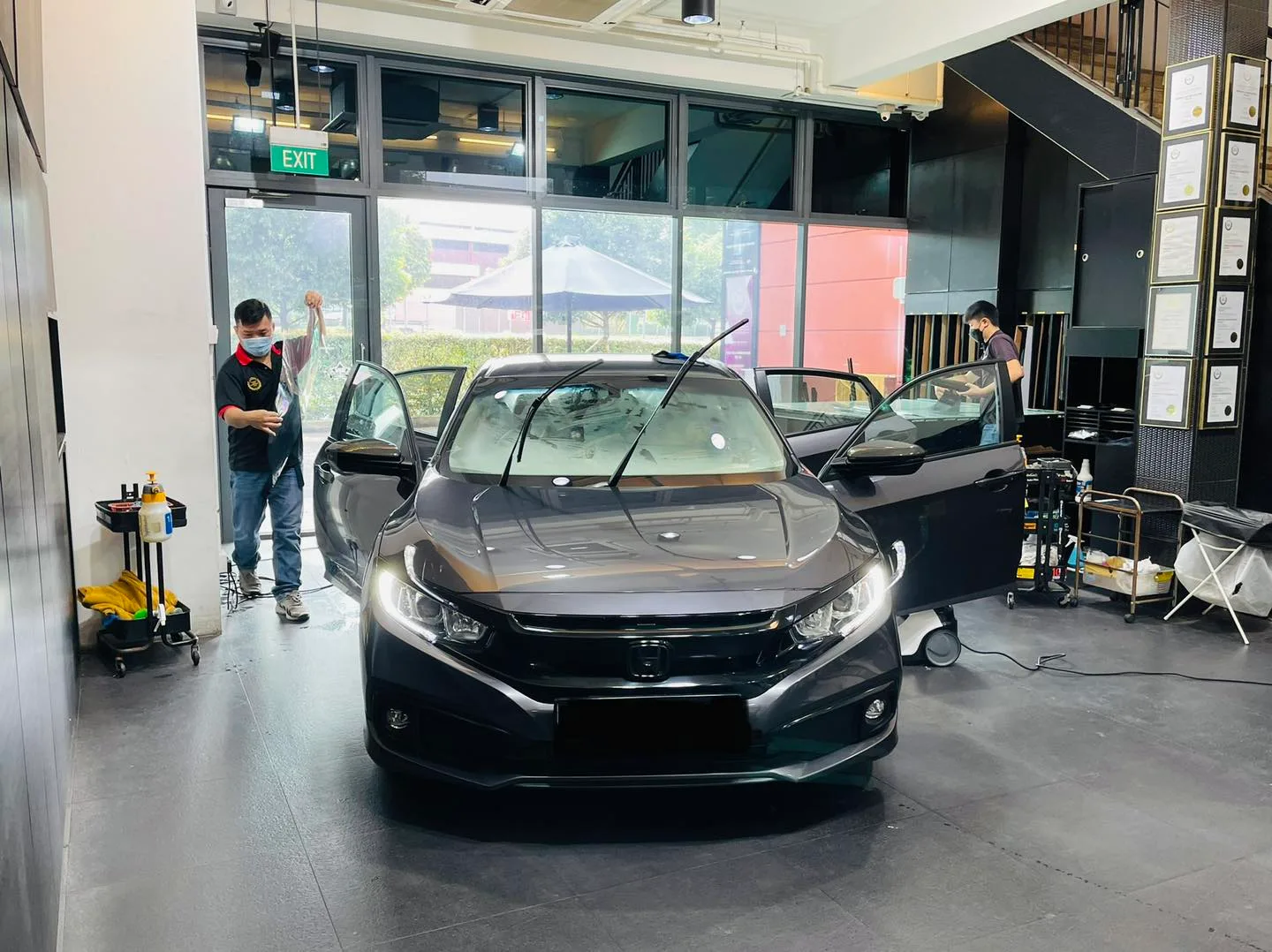 Grey Honda Civic with doors open during window tinting at Infratint Singapore