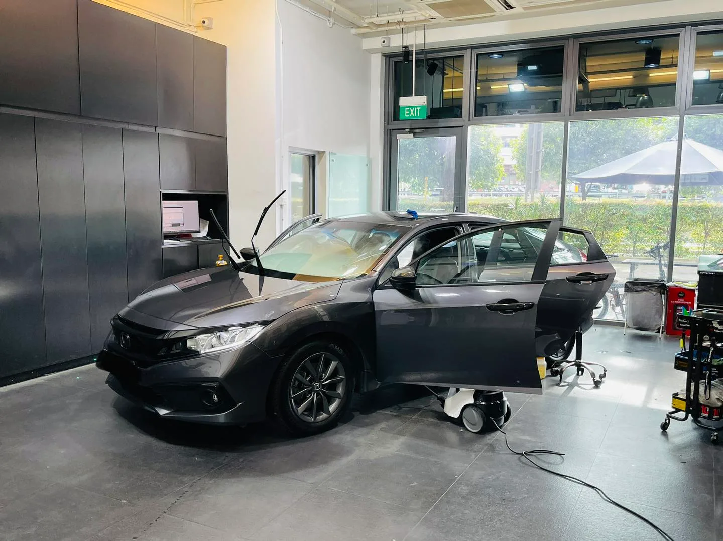 Side profile of a grey Honda Civic during window film install at Infratint Singapore