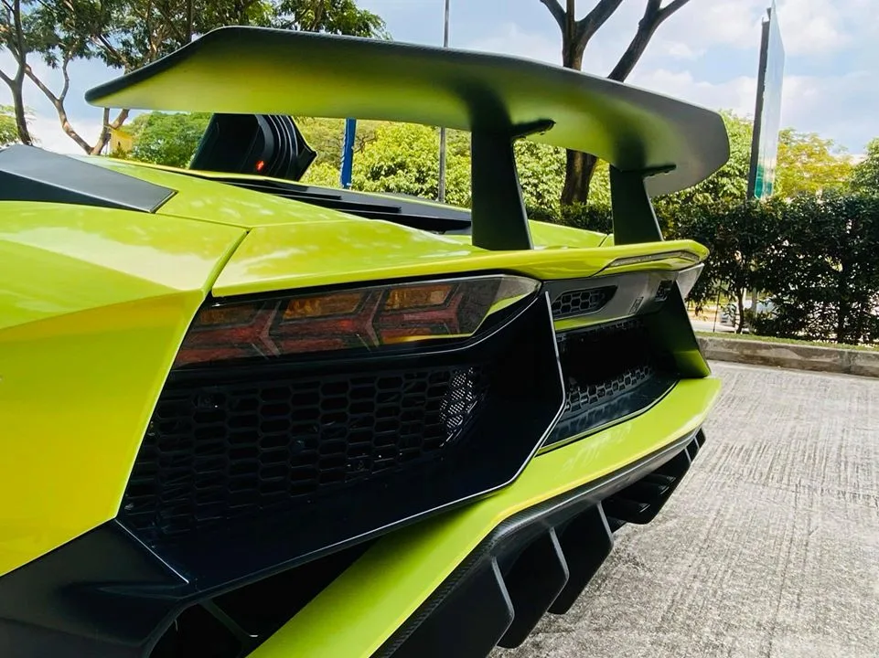 Detail of the rear wing and taillight on a green Lamborghini Aventador at Infratint Singapore