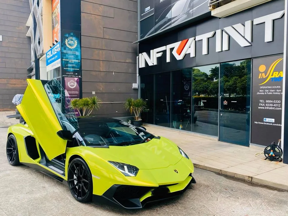Lime green Lamborghini Aventador with scissor door open at Infratint Singapore