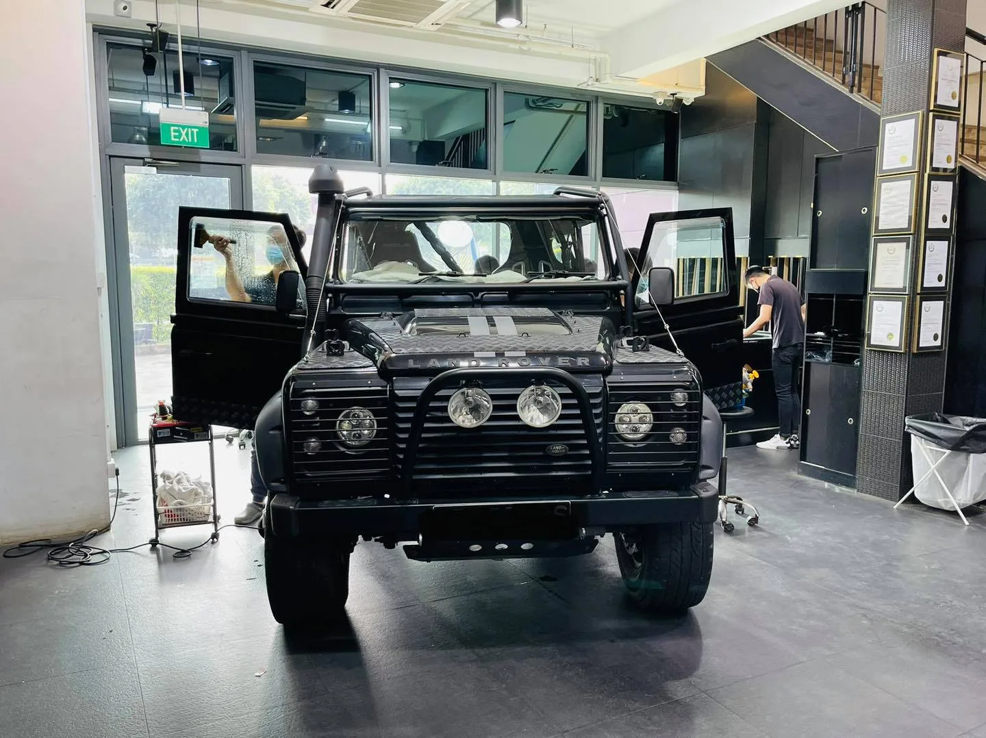 Black Land Rover Defender with doors open before window tinting at Infratint Singapore