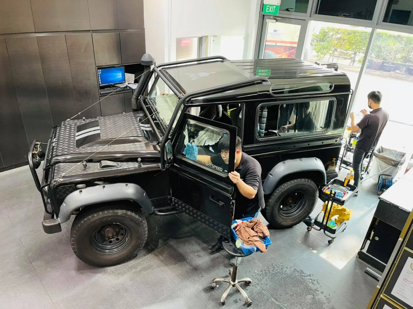 Overhead view of a black Land Rover Defender being tinted at Infratint Singapore
