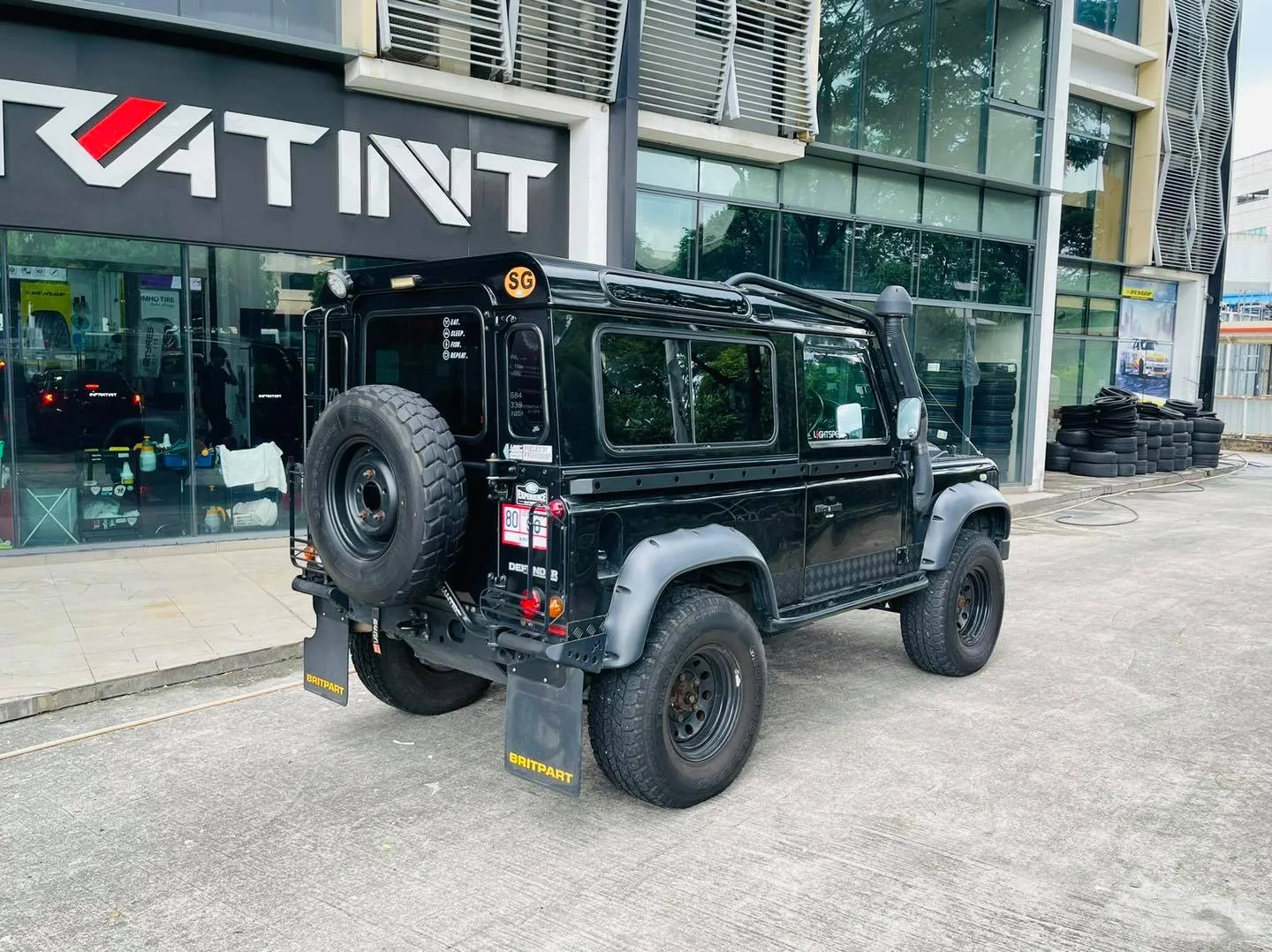 Rear view of a black Land Rover Defender at Infratint Singapore