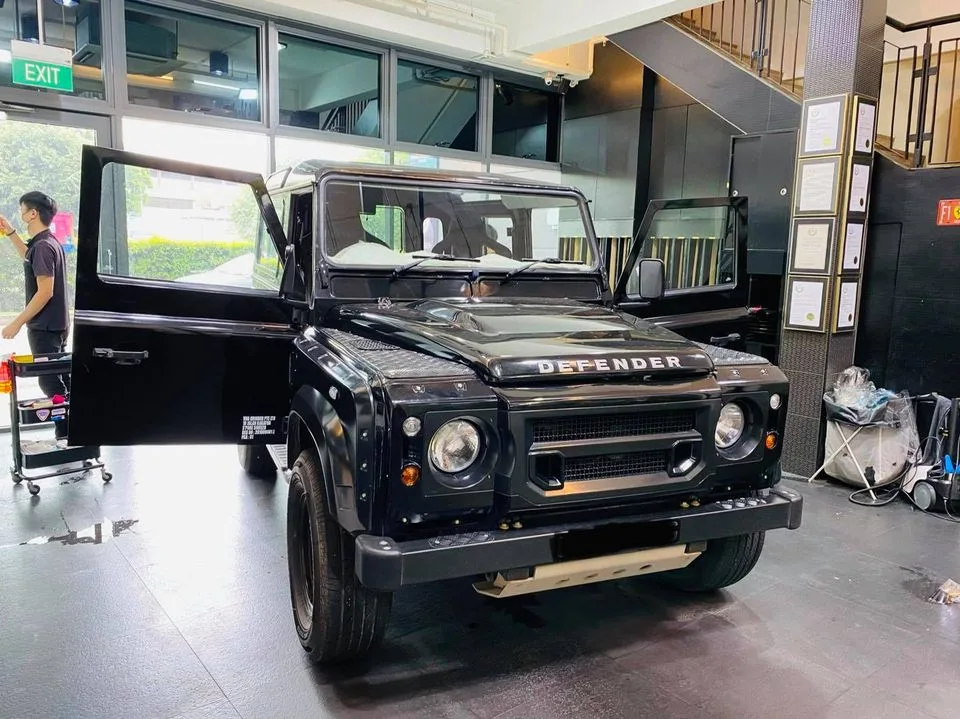 Black Land Rover Defender with door open for window film at Infratint Singapore