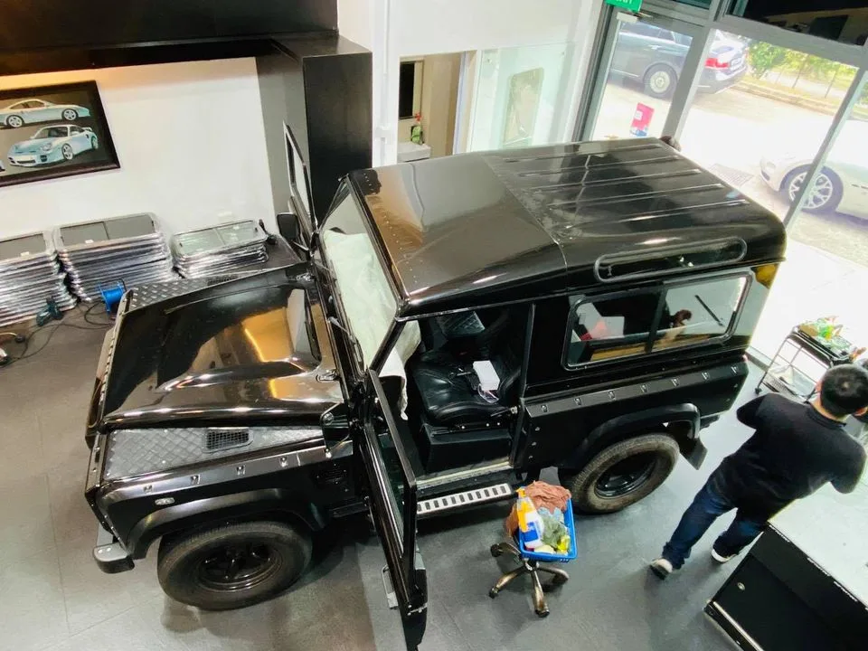 Overhead view of a black Land Rover Defender during window tinting at Infratint Singapore