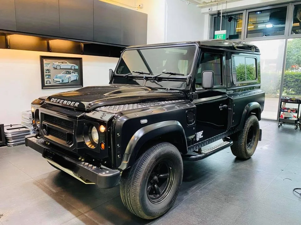 Black Land Rover Defender three-quarter view at Infratint Singapore for window film