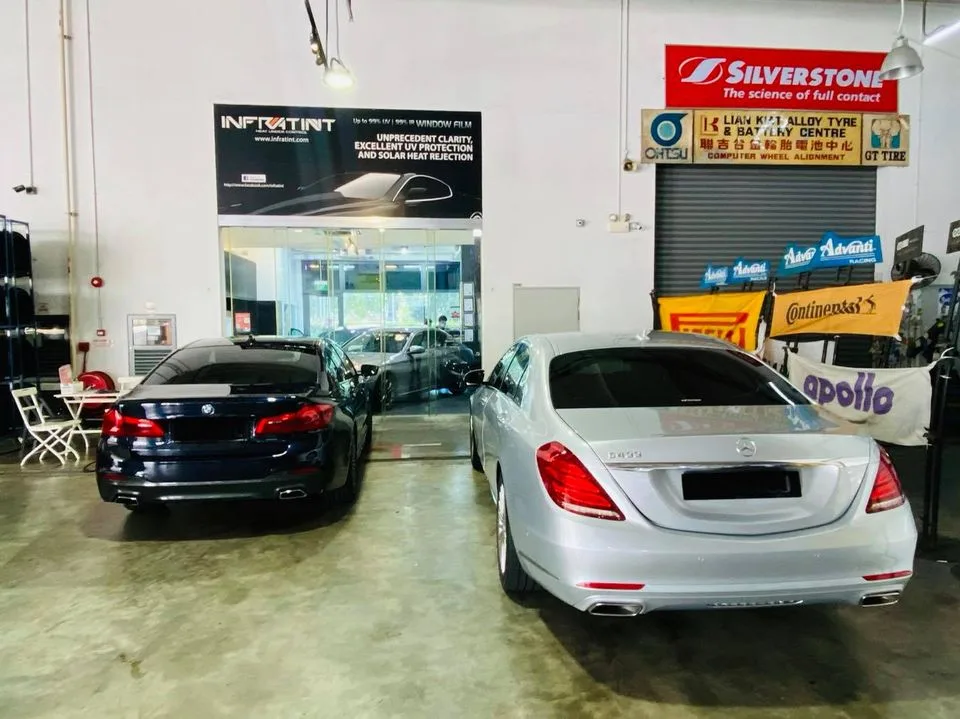 Dark blue BMW 5 Series and silver Mercedes-Benz S-Class at Infratint Singapore