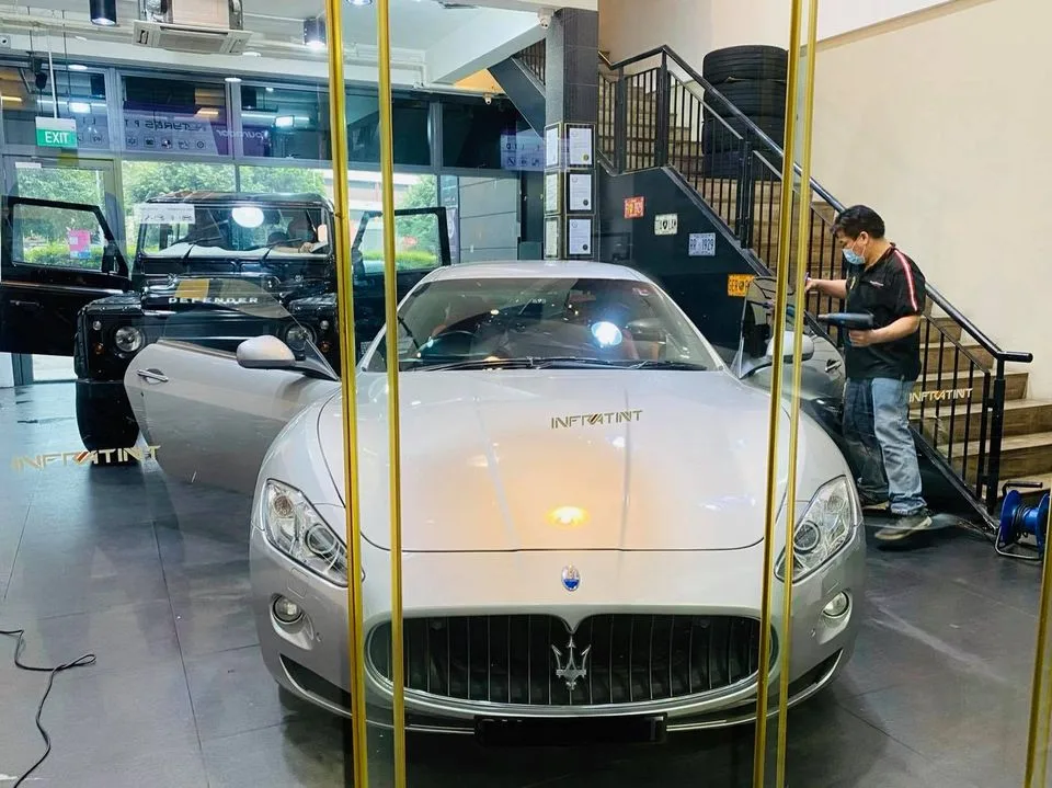 Silver Maserati GranTurismo and a black Land Rover Defender at Infratint Singapore