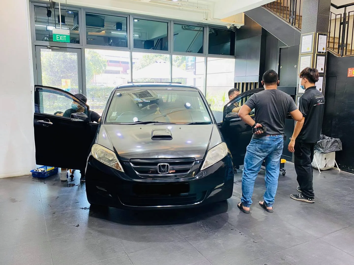Black Honda MPV with staff during window tinting at Infratint Singapore