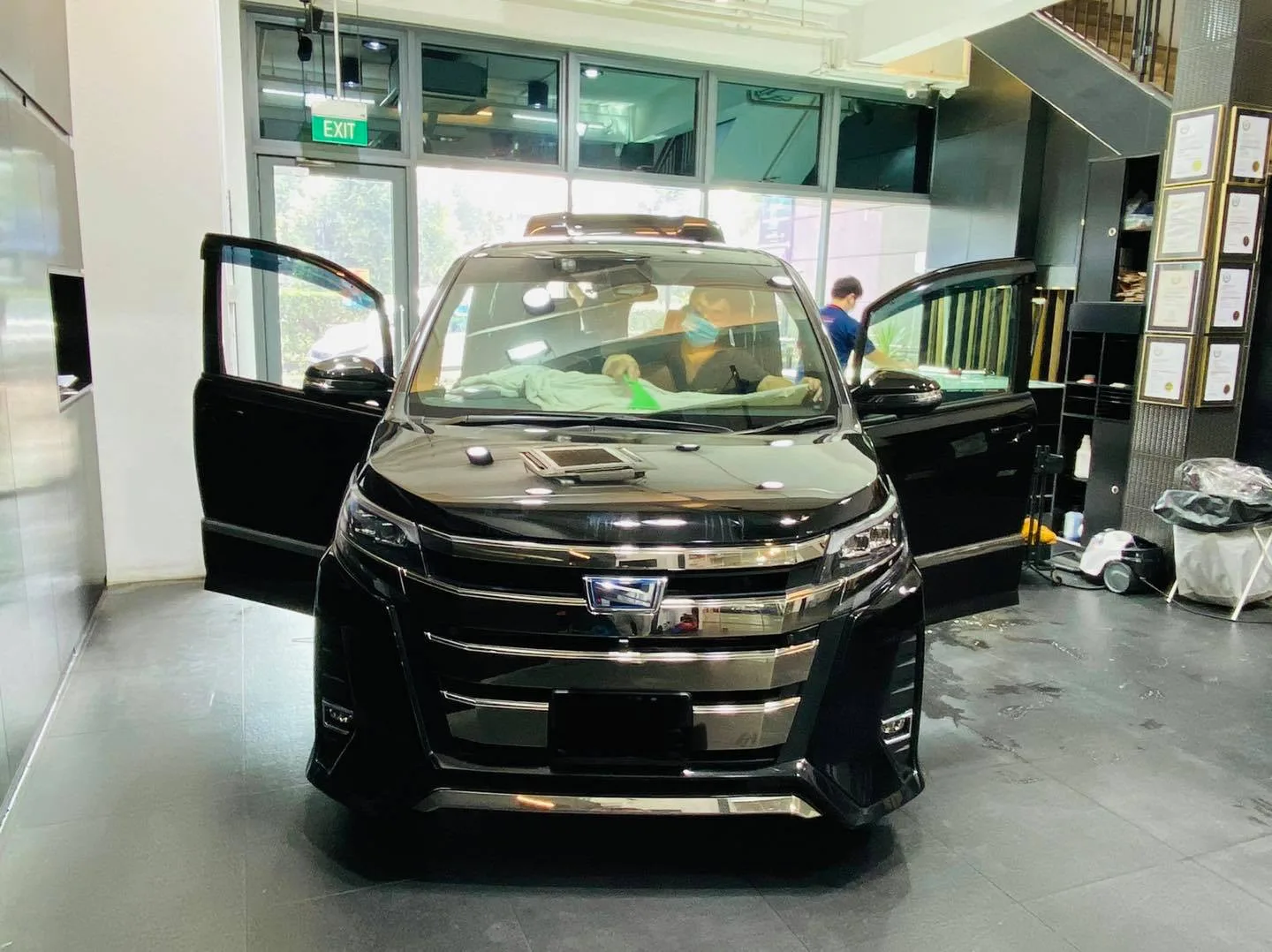 Black Toyota Noah MPV with front doors open for window tinting at Infratint Singapore