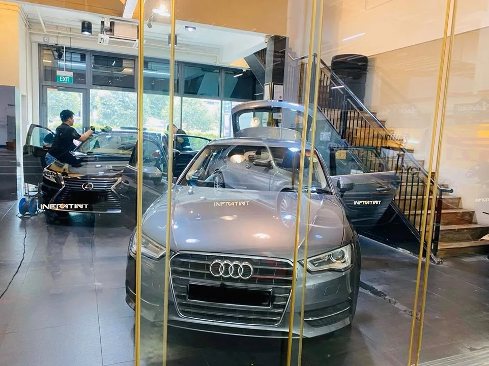 Grey Audi A3 and black Lexus sedan being tinted at Infratint Singapore