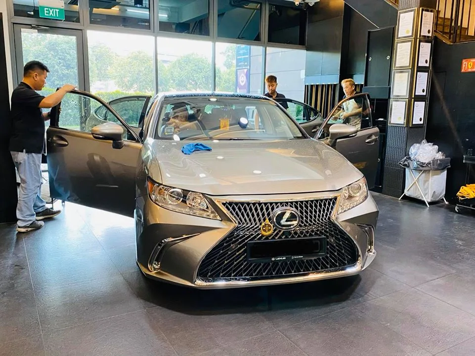 Champagne Lexus ES sedan front view with doors open during tinting at Infratint Singapore