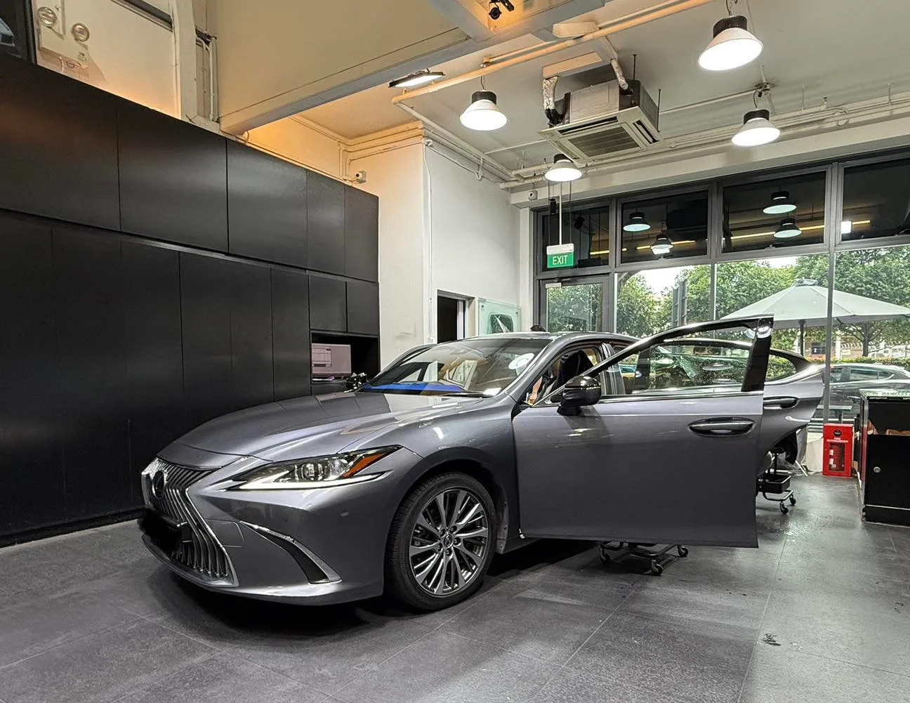 Grey Lexus ES300h front three-quarter during window film install at Infratint Singapore