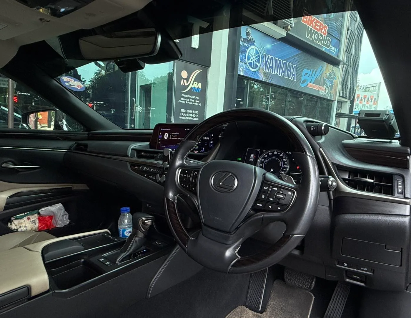 Lexus ES300h interior steering wheel and dashboard seen through tinted glass at Infratint Singapore