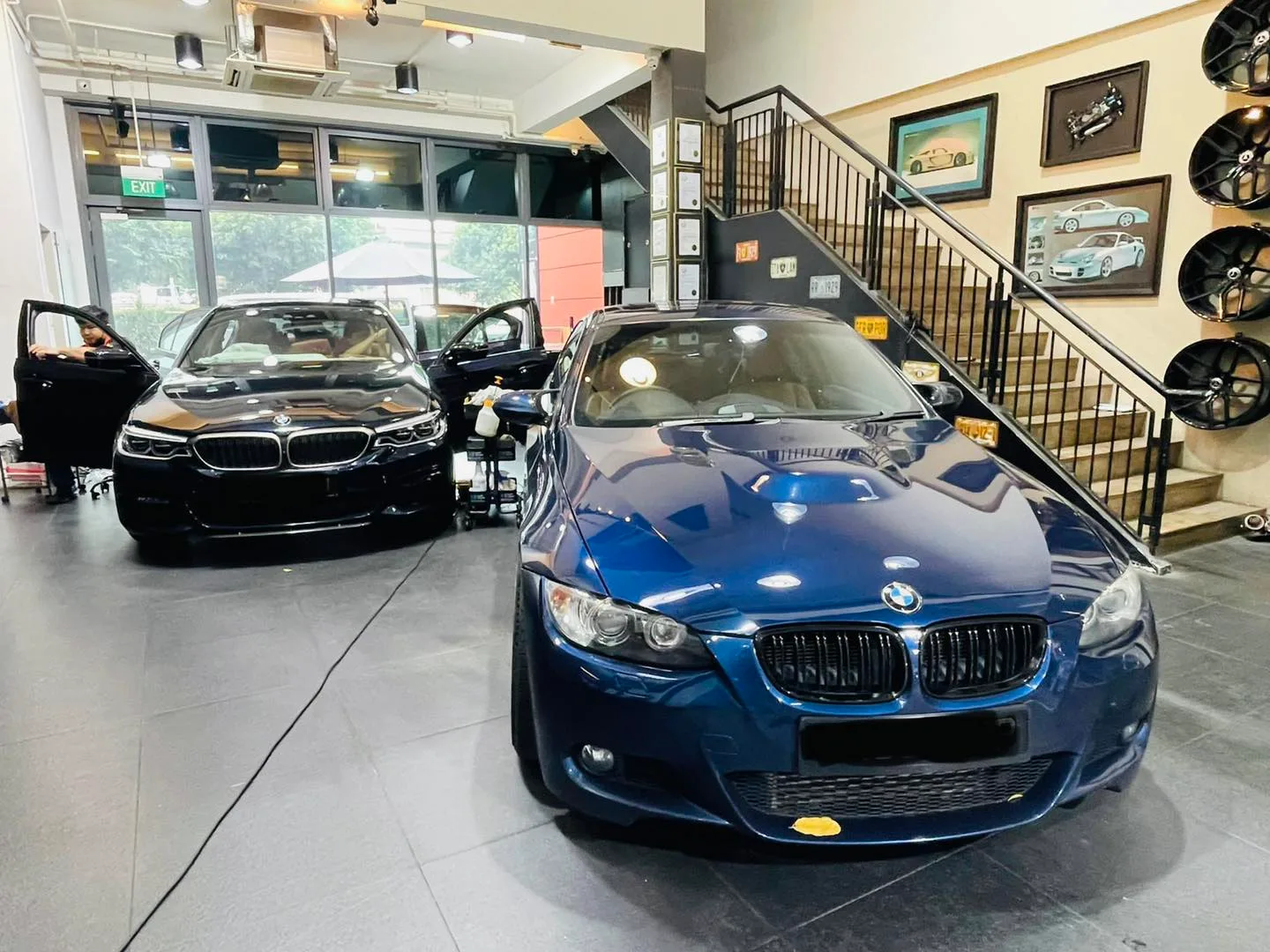 Dark blue BMW 3 Series coupe and black BMW sedan at Infratint Singapore window tinting workshop