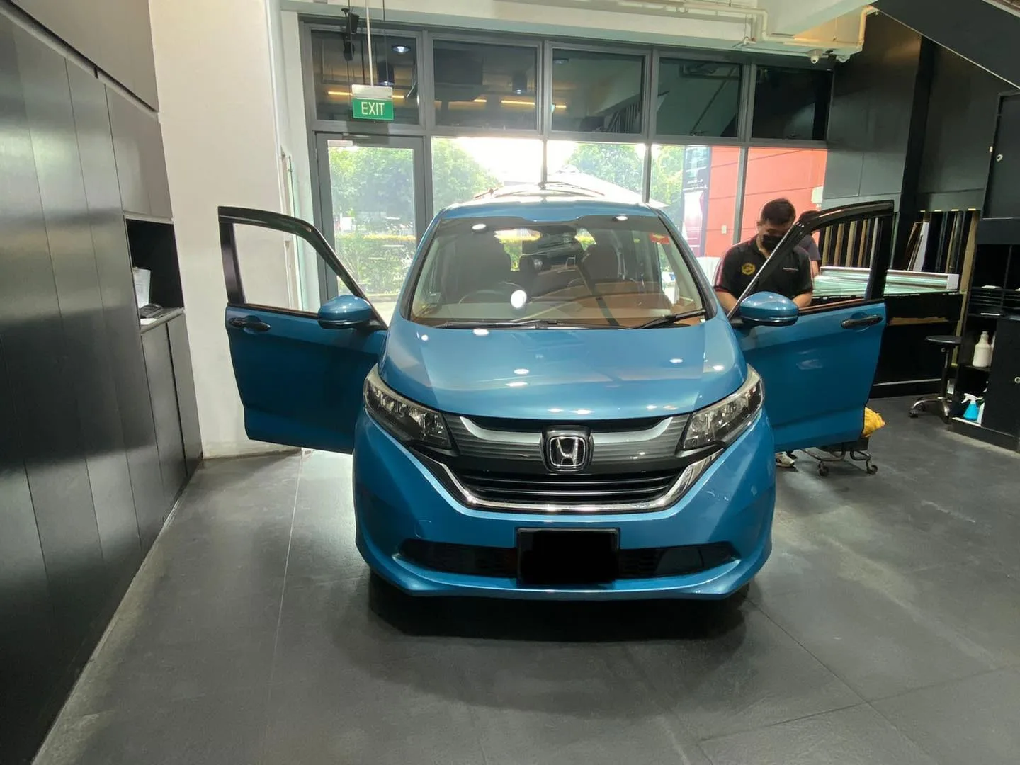 Blue Honda Freed MPV with doors open for window tinting at Infratint Singapore