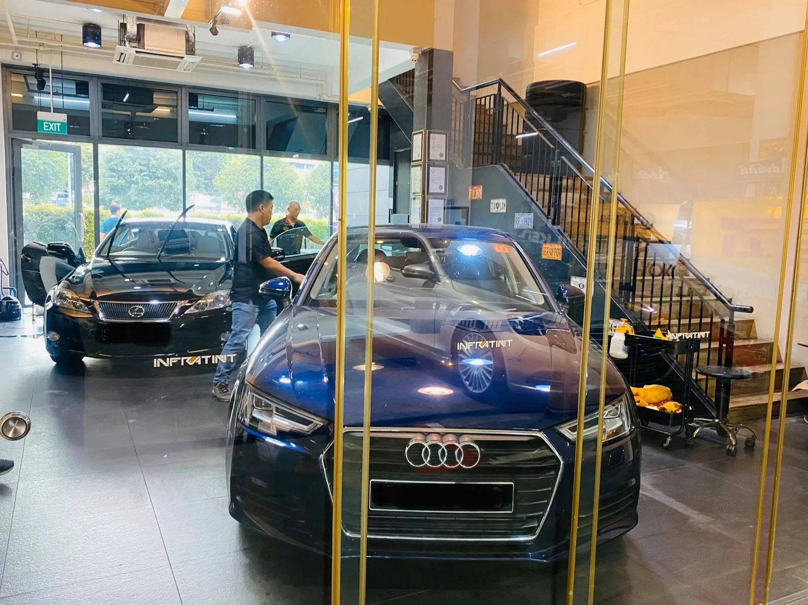 Blue Audi A4 and black Lexus sedan during tinting at Infratint Singapore
