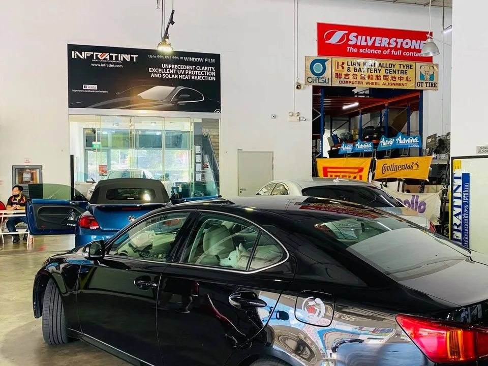 Black Lexus IS sedan and blue Volkswagen Scirocco at Infratint Singapore