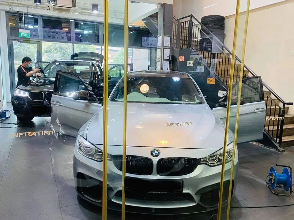 Silver BMW M4 coupe viewed through glass at Infratint Singapore