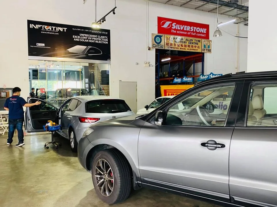 Silver hatchback and SUV during window tinting at Infratint Singapore