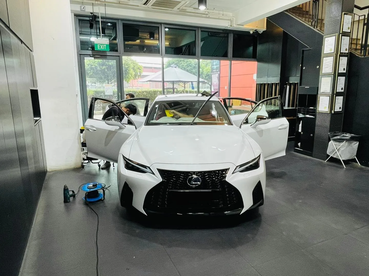 White Lexus IS sedan with doors open before window tinting at Infratint Singapore