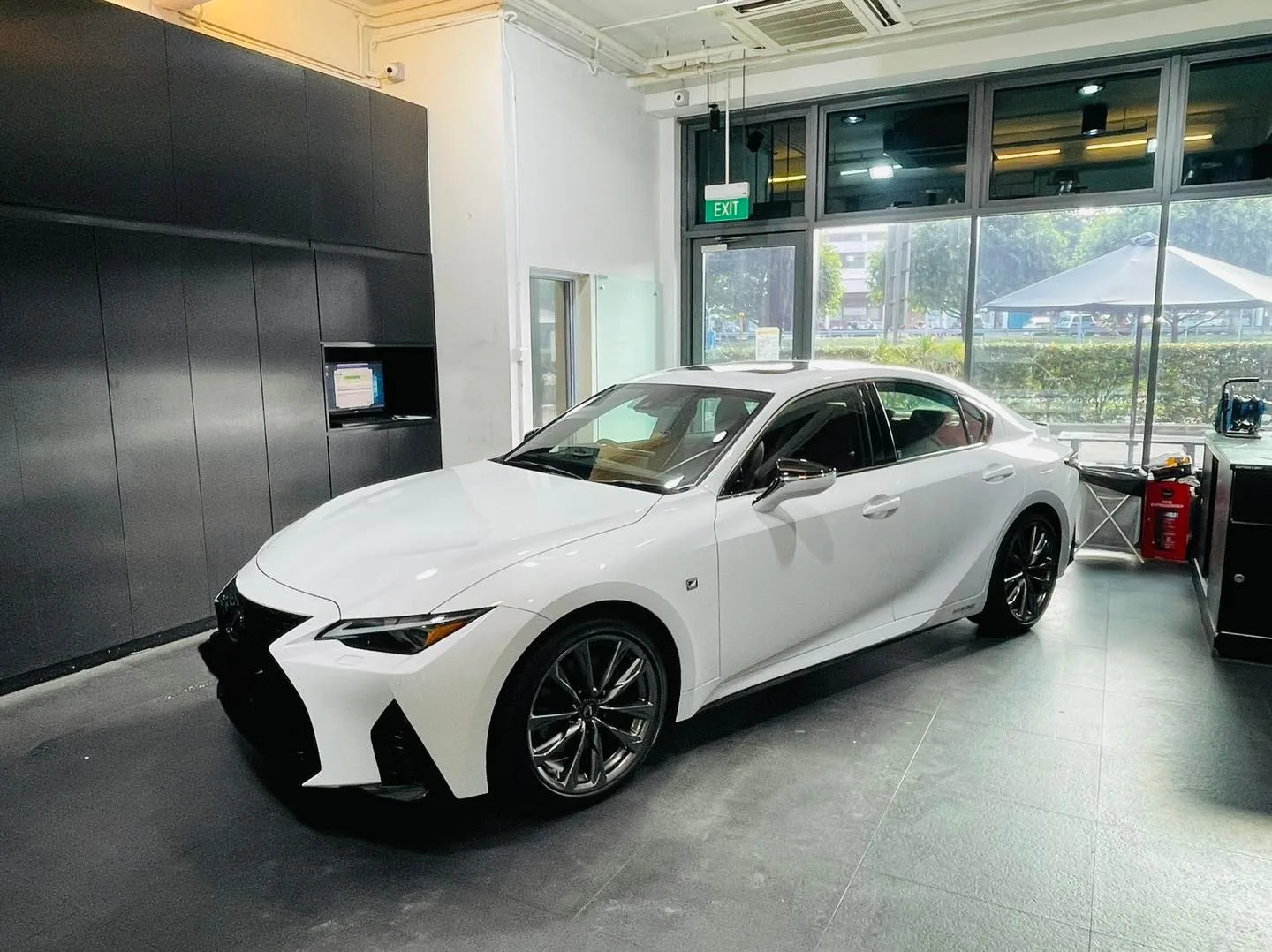 White Lexus IS sedan parked in the showroom at Infratint Singapore
