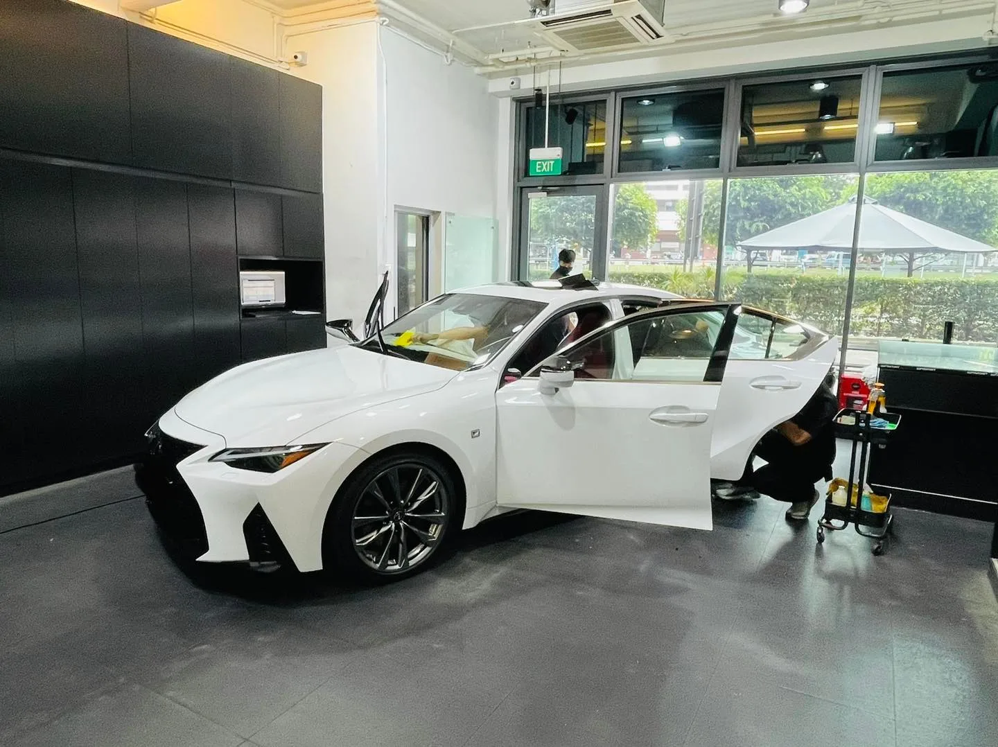 White Lexus IS sedan front three-quarter during window tinting at Infratint Singapore