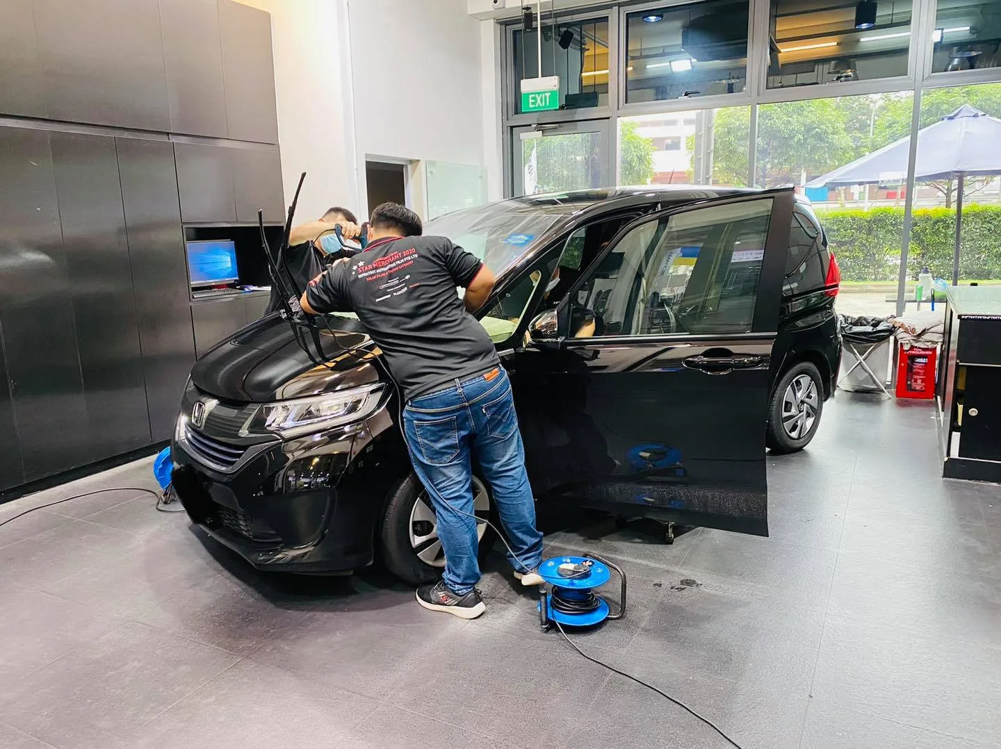 Black Honda MPV during window film installation at Infratint Singapore
