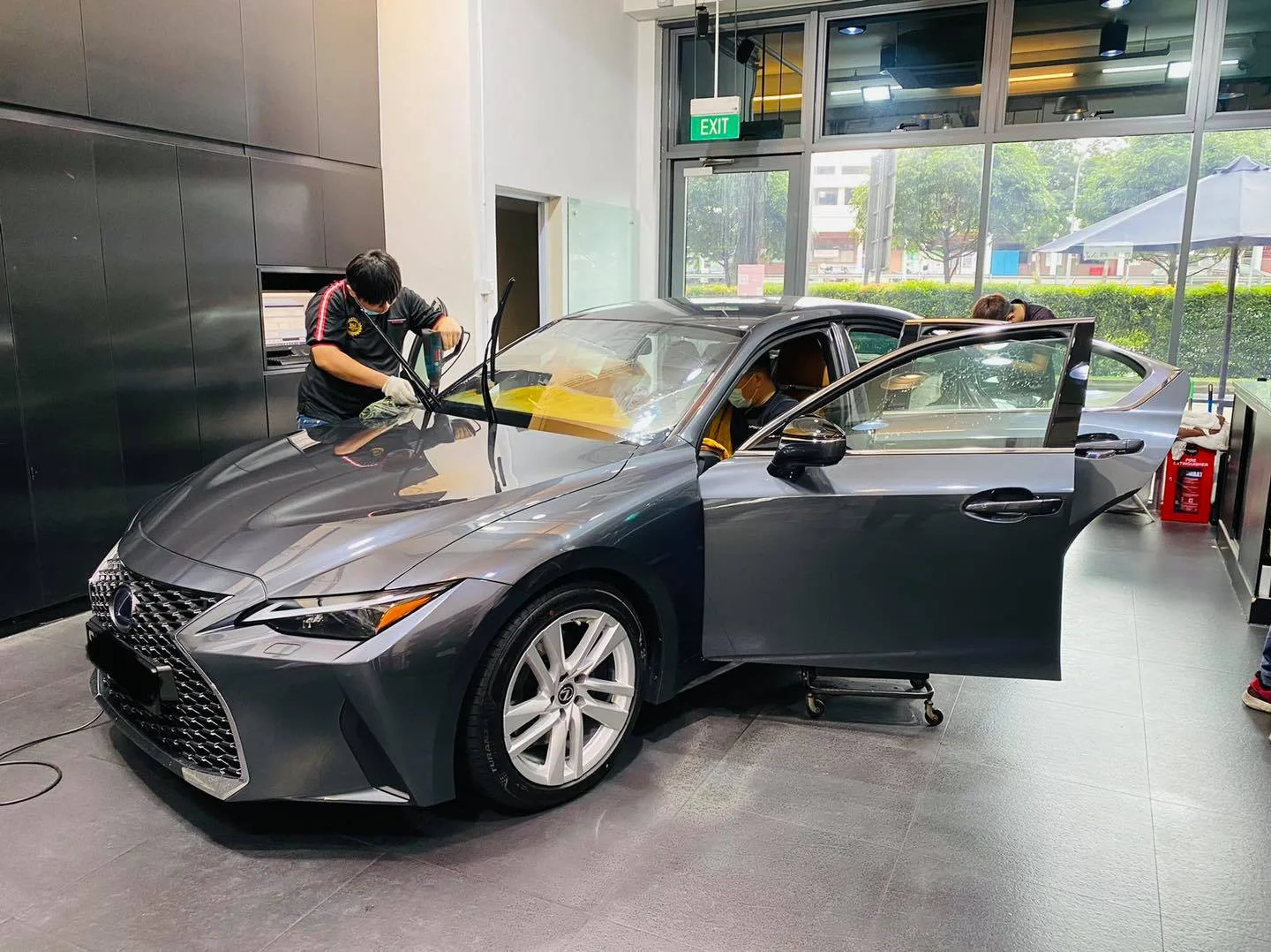 Grey Lexus sedan with door open during window tinting at Infratint Singapore