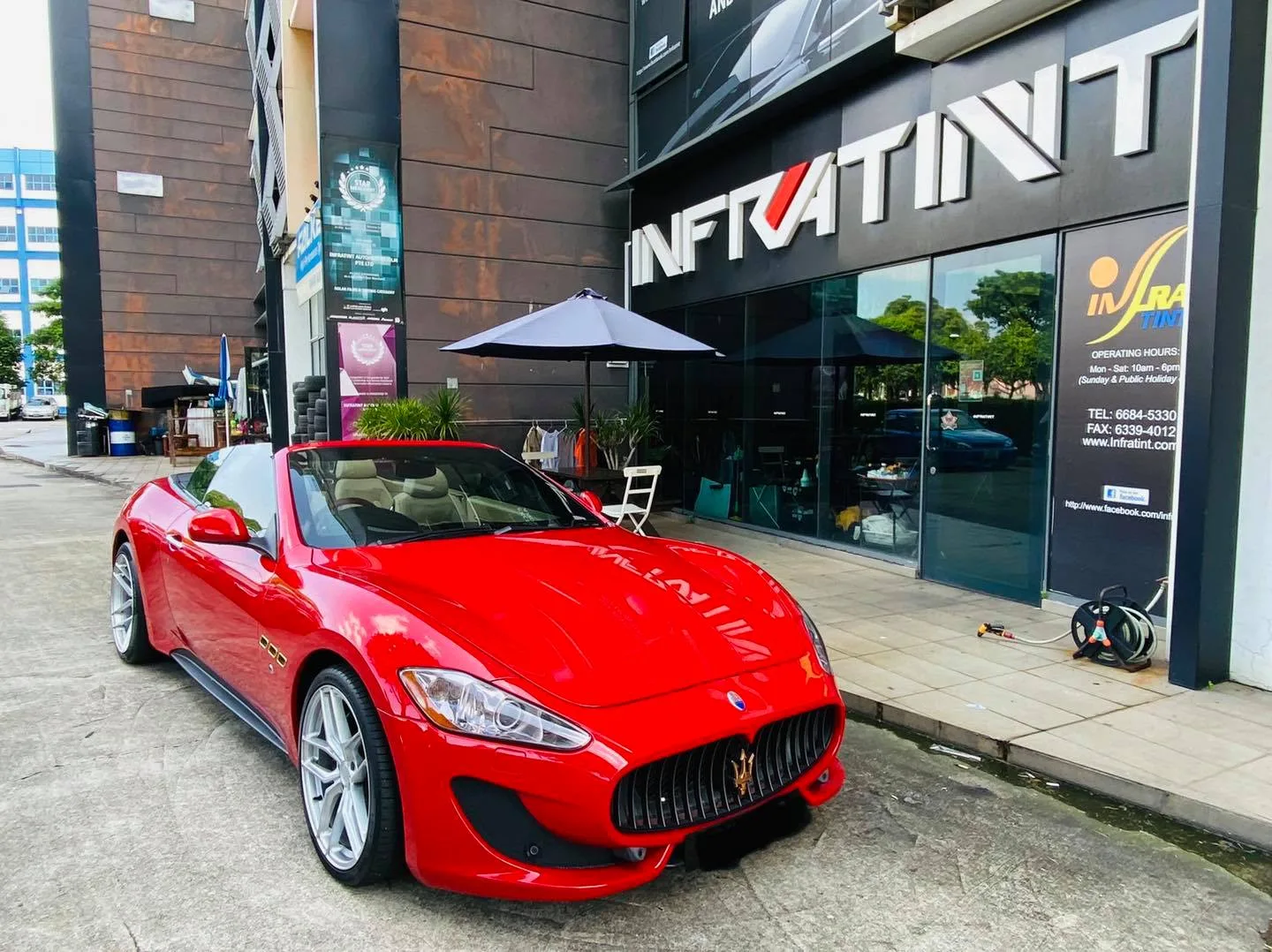 Red Maserati GranCabrio parked outside the Infratint Singapore shopfront