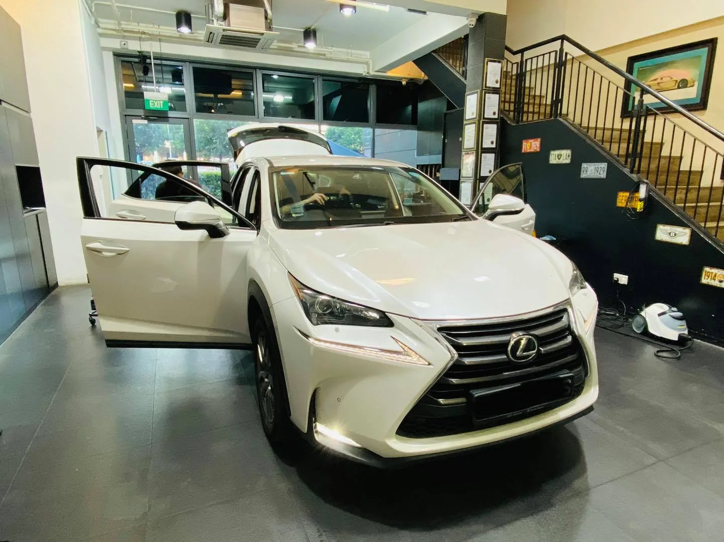 White Lexus NX SUV with doors open during window tinting at Infratint Singapore
