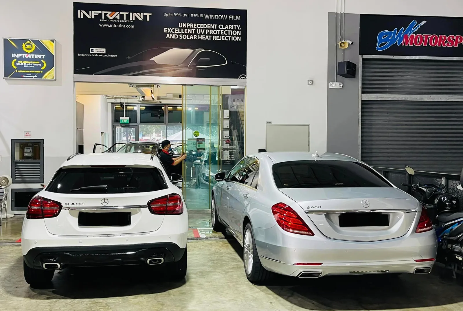 White Mercedes-Benz GLA and silver Mercedes-Benz sedan in the install bay at Infratint Singapore