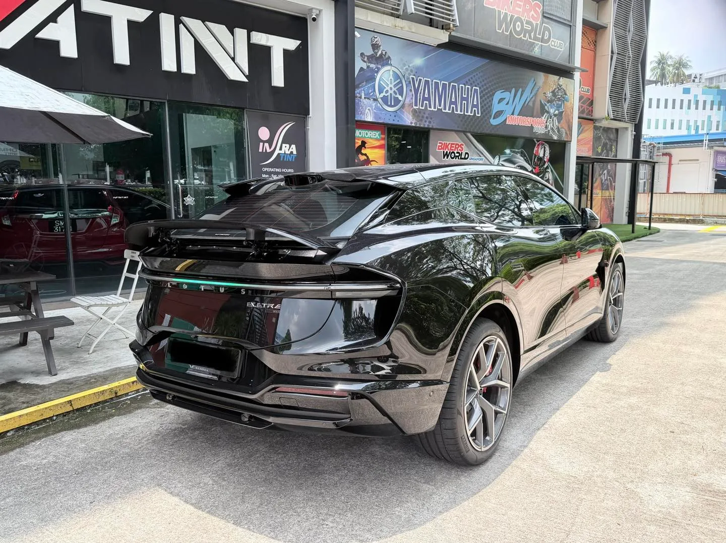 Tinted Lotus Eletre rear three-quarter view with active spoiler at Infratint Singapore