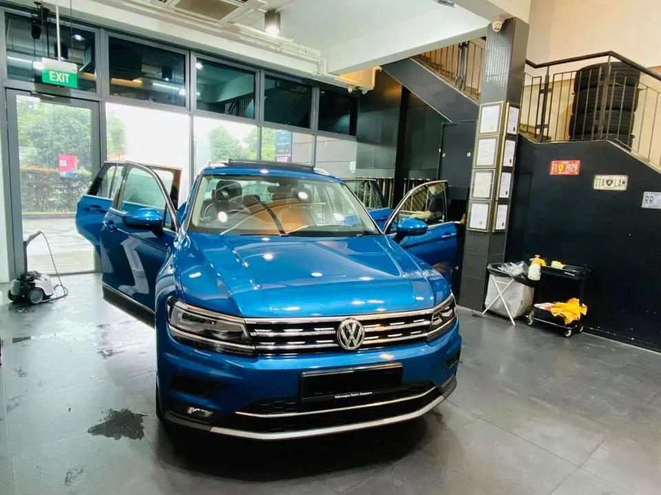 Blue Volkswagen Tiguan SUV prepped for window film at Infratint Singapore