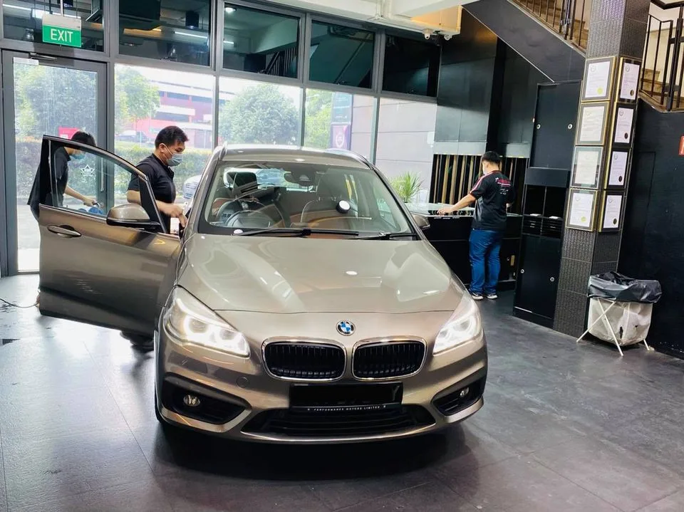 Bronze BMW 2 Series Tourer being prepared for tinting at Infratint Singapore